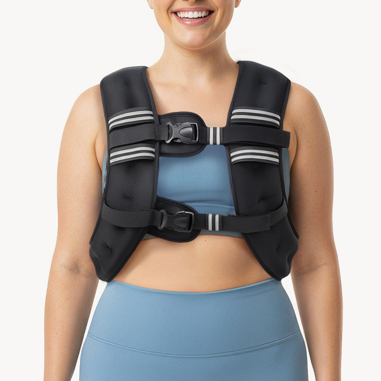 Person wearing a black weighted vest over a blue athletic outfit on a white background
