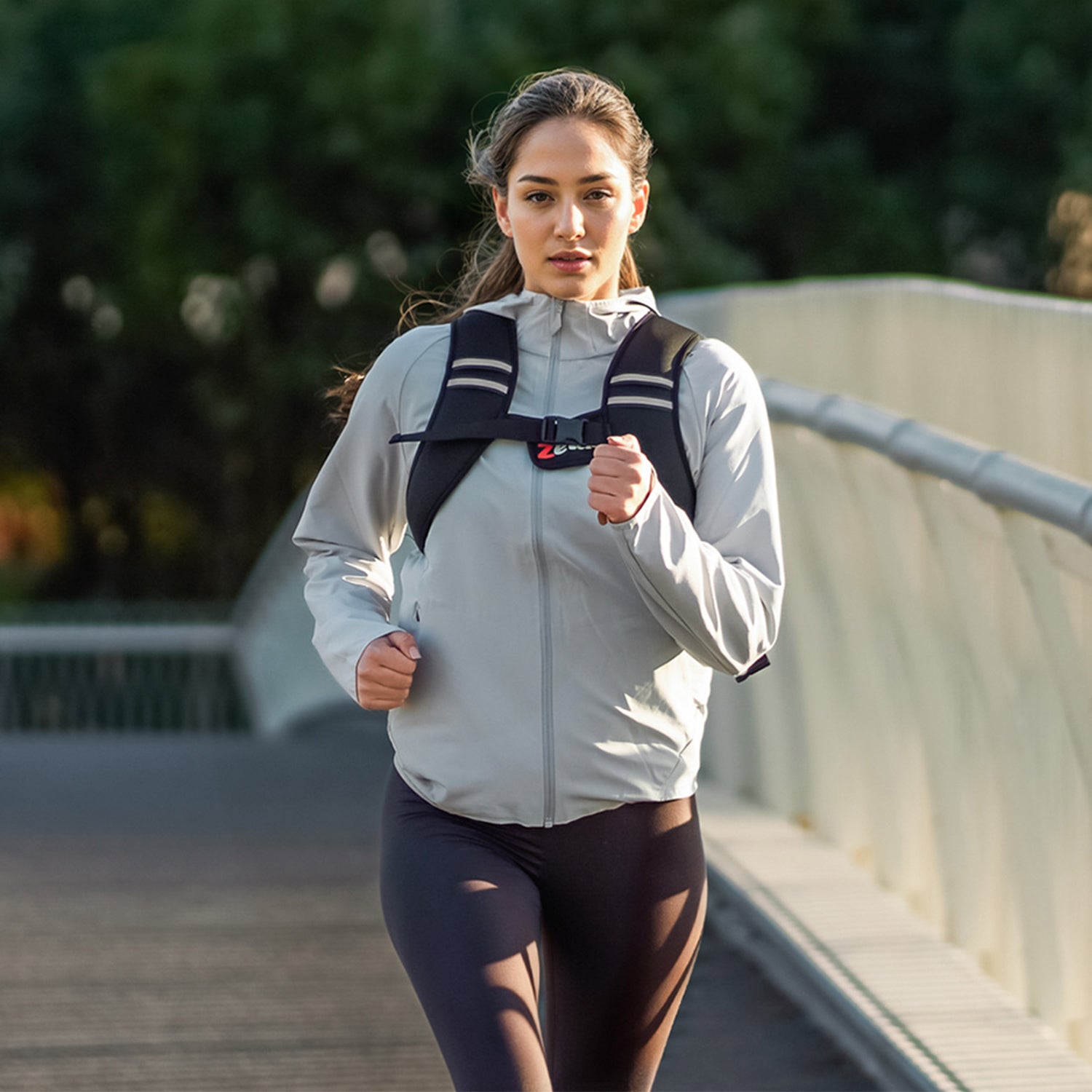 Woman running outdoors on a bridge with a backpack