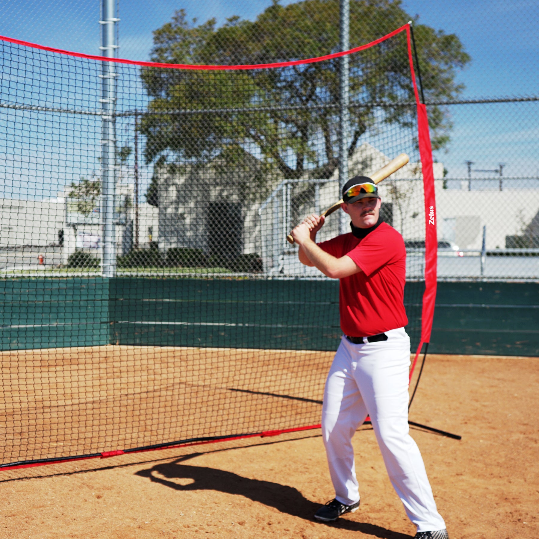 Person standing in front of a large red and black sports net 
