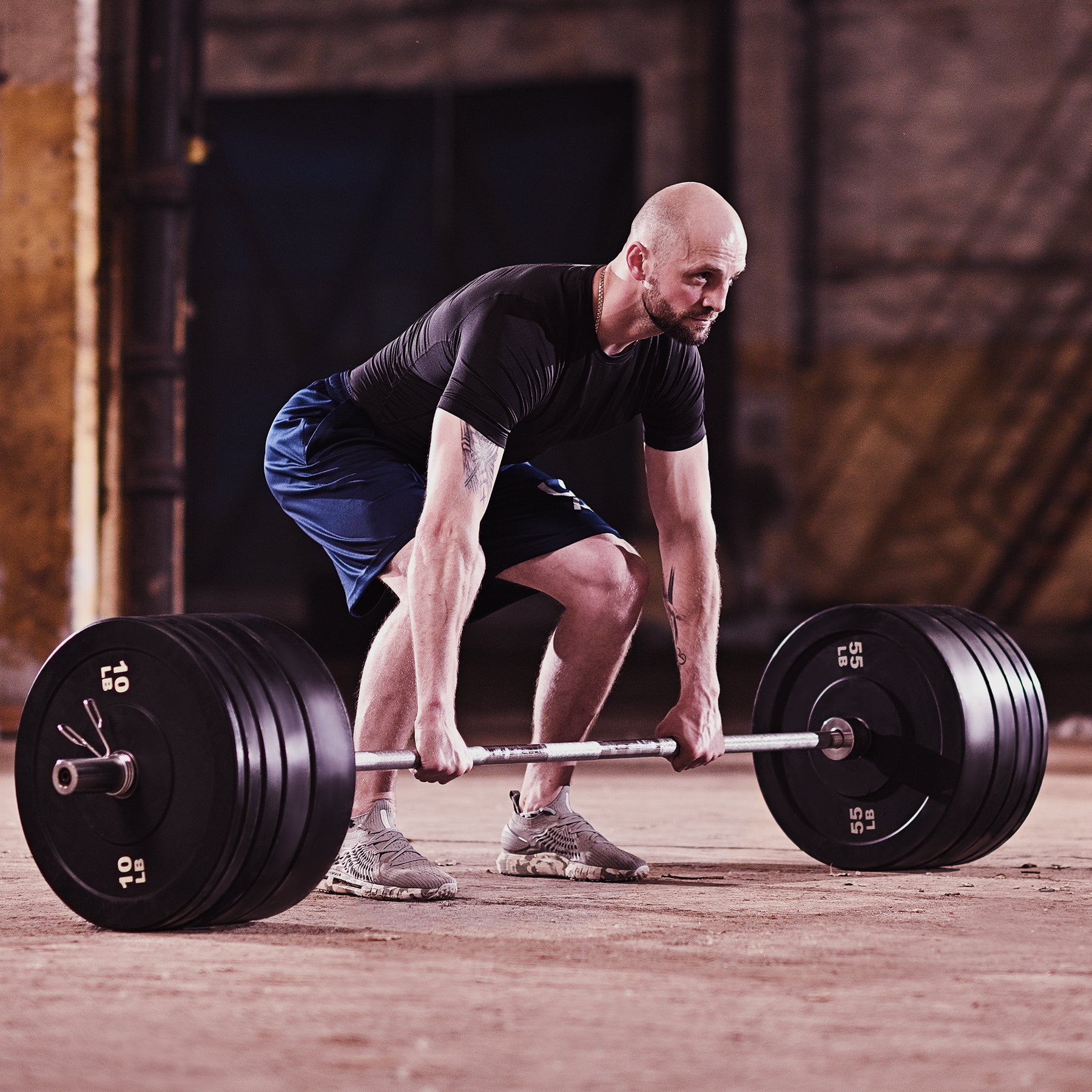 Two black weight plates with '25 LB' marking on a white background