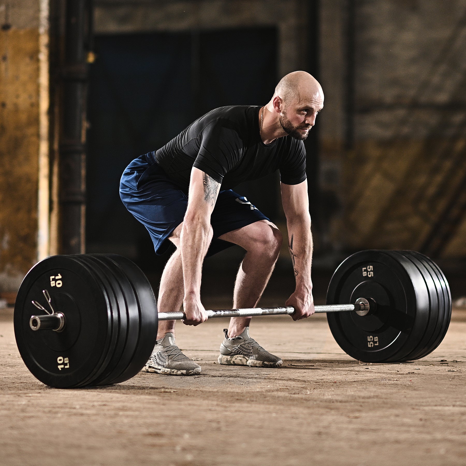 Set of black weight plates with labeled weight capacities