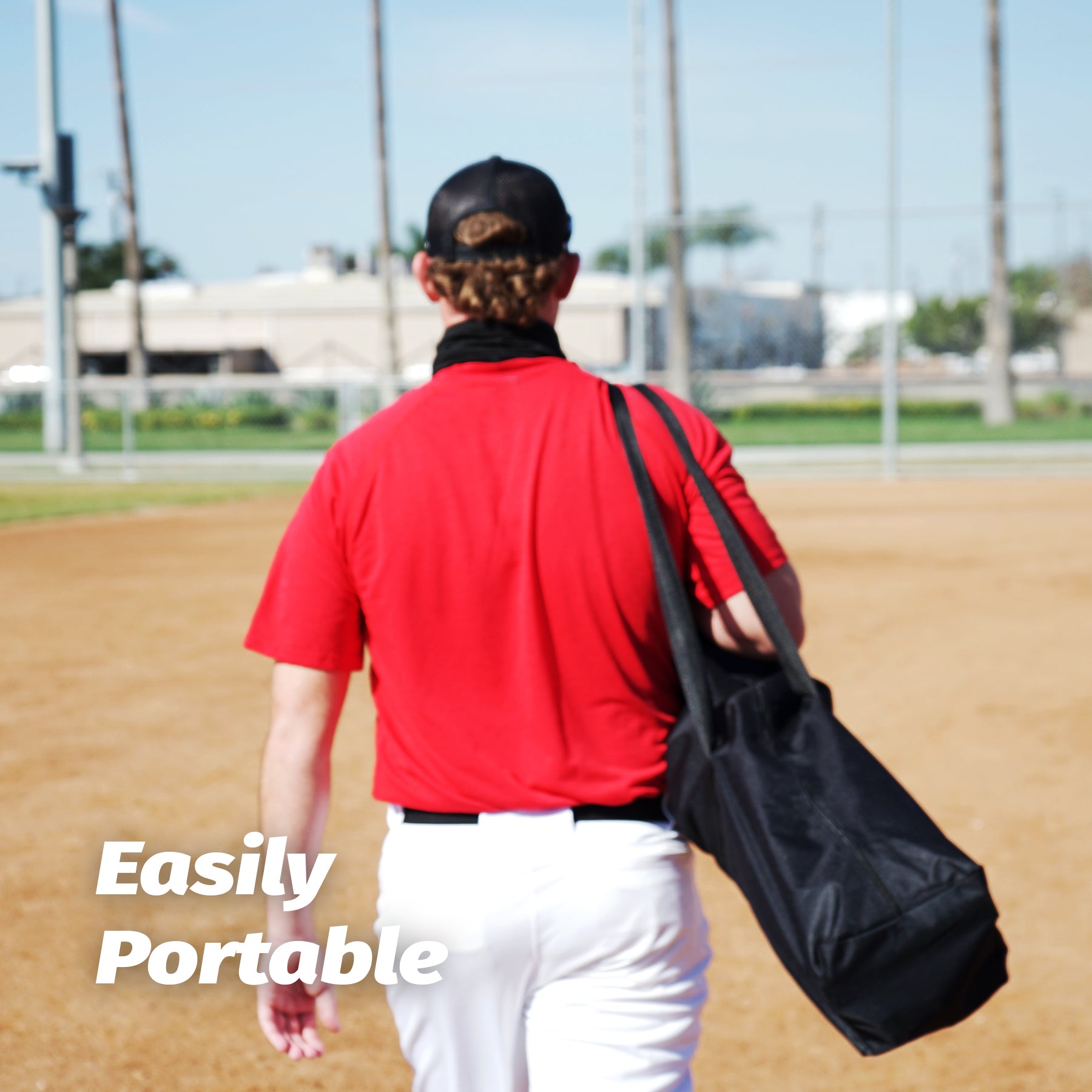 Person standing in front of a large red and black sports net 